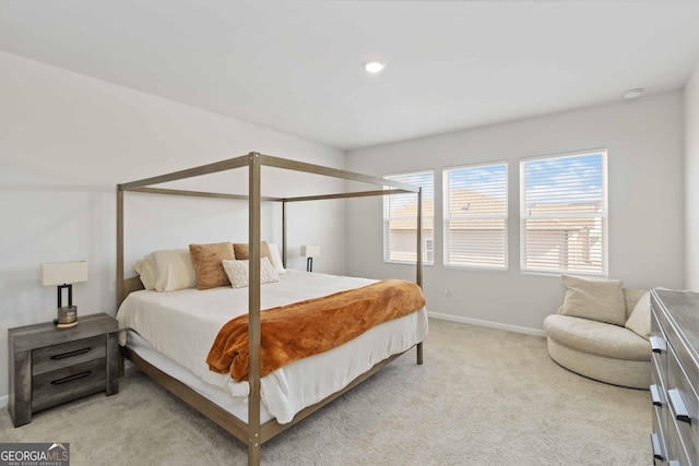 bedroom featuring light colored carpet and baseboards