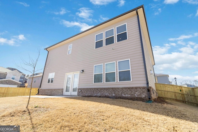 rear view of property with fence