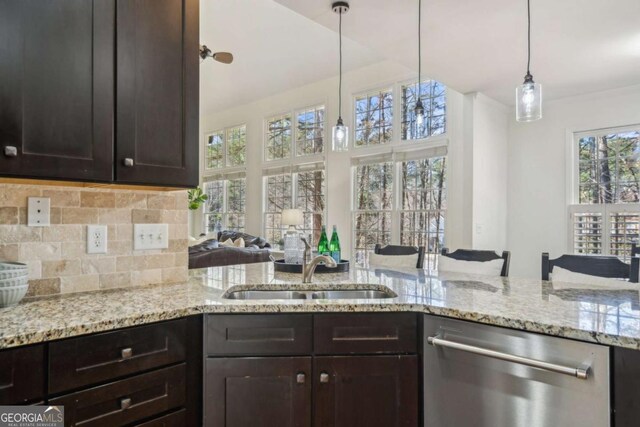 kitchen with a sink, tasteful backsplash, dishwasher, and dark brown cabinetry