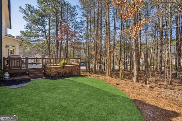 view of yard featuring a wooden deck