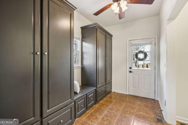 mudroom with tile patterned flooring, baseboards, visible vents, and ceiling fan