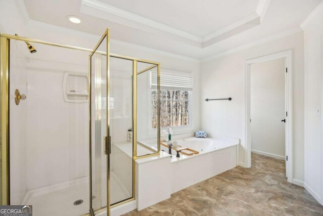 bathroom with a tray ceiling, a stall shower, crown molding, and a garden tub