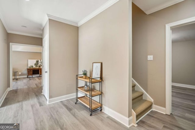 corridor featuring crown molding, stairway, wood finished floors, and baseboards