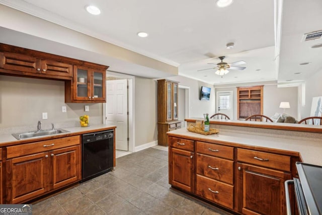 kitchen with a sink, visible vents, black dishwasher, and light countertops