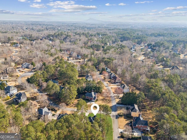 drone / aerial view featuring a forest view