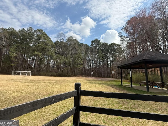 view of yard featuring a gazebo and a view of trees