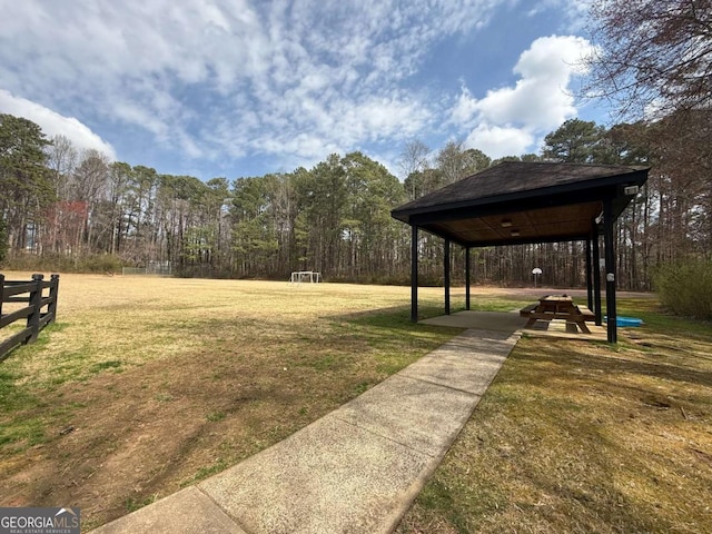 view of yard with a gazebo and a view of trees