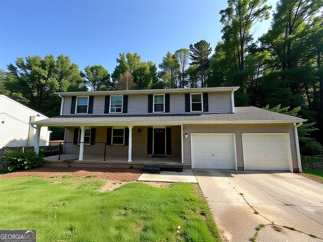 view of front of property featuring a garage, a porch, concrete driveway, and a front yard