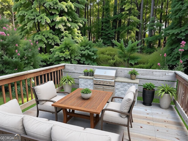 wooden terrace featuring outdoor dining space, exterior kitchen, area for grilling, and an outdoor hangout area