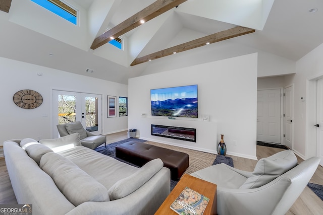 living area featuring visible vents, baseboards, beam ceiling, french doors, and wood finished floors