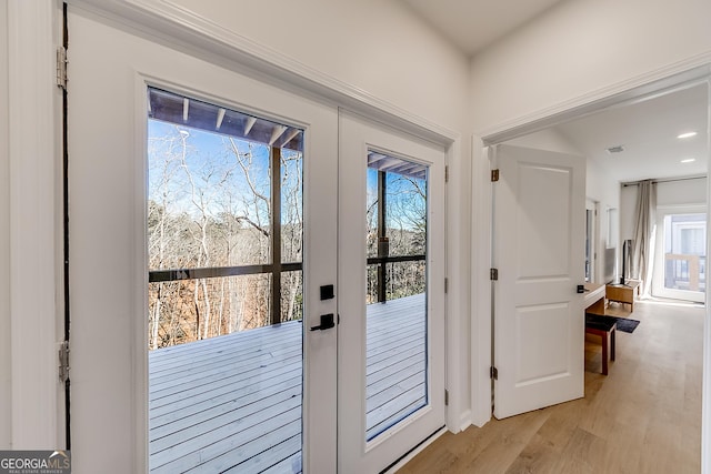 doorway with recessed lighting, french doors, and light wood-type flooring