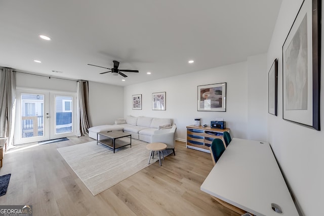 living room with recessed lighting, light wood-style flooring, and french doors