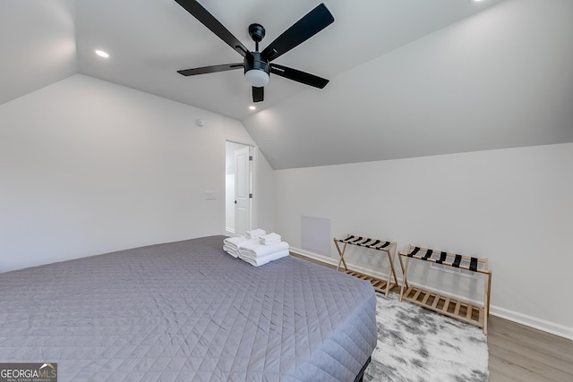 bedroom with a ceiling fan, lofted ceiling, recessed lighting, and wood finished floors