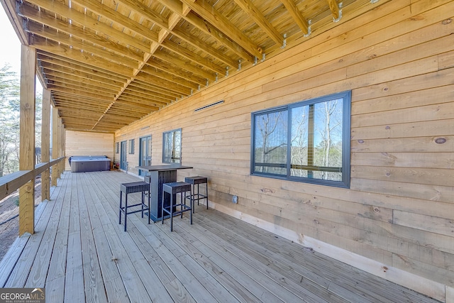 wooden terrace with a hot tub