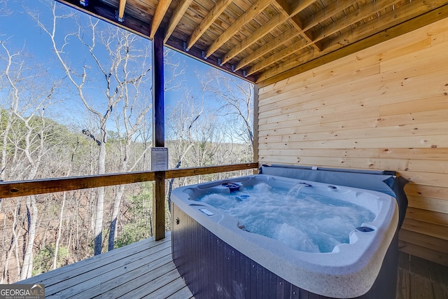 wooden terrace featuring a hot tub