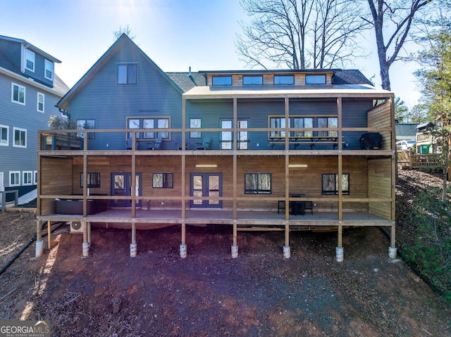 rear view of property with a shingled roof