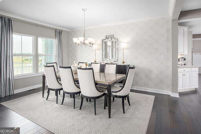 dining area featuring baseboards, a notable chandelier, dark wood finished floors, and wallpapered walls