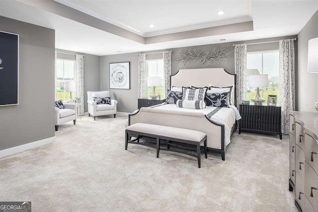 bedroom with light carpet, a tray ceiling, recessed lighting, crown molding, and baseboards