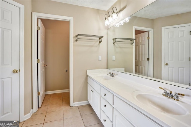 full bathroom with tile patterned floors, baseboards, and a sink