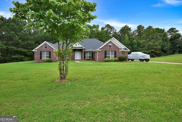 view of front of home featuring a front lawn and brick siding