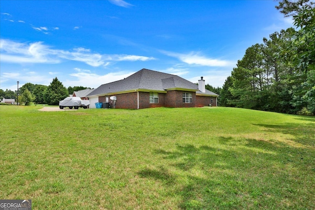 view of home's exterior with brick siding, a lawn, a chimney, and roof with shingles