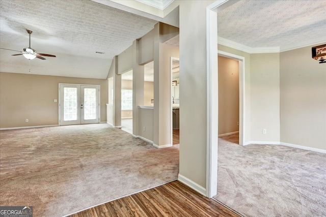 unfurnished room featuring french doors, a ceiling fan, carpet floors, and a textured ceiling