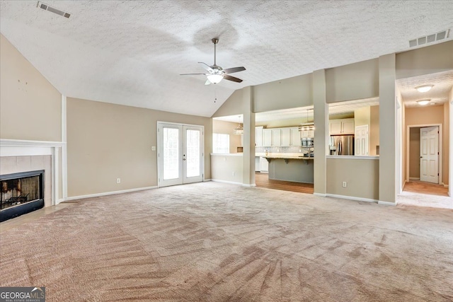 unfurnished living room featuring light carpet, french doors, visible vents, and ceiling fan