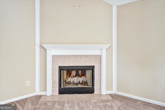 room details featuring carpet flooring, baseboards, and a tile fireplace