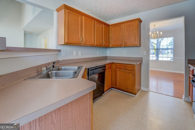 kitchen with a sink, black dishwasher, a textured ceiling, an inviting chandelier, and light countertops