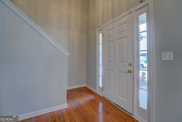 entryway with hardwood / wood-style flooring and baseboards