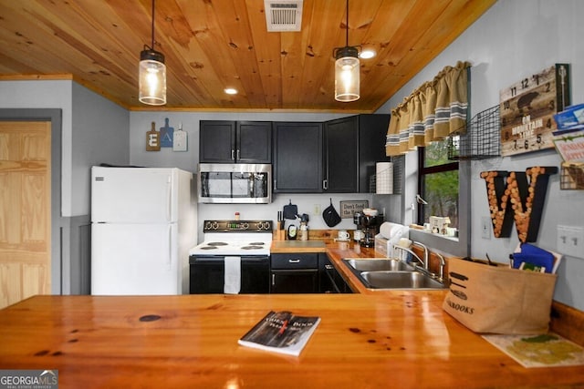 kitchen with stainless steel microwave, range with electric cooktop, visible vents, freestanding refrigerator, and a sink