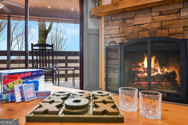 details featuring an outdoor stone fireplace and white cooktop