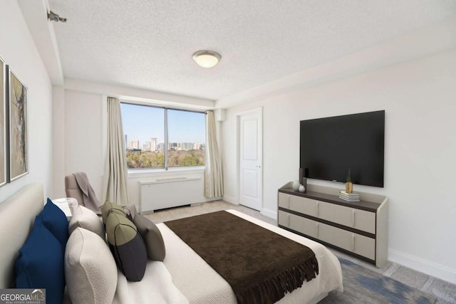 carpeted bedroom featuring baseboards, a textured ceiling, and radiator heating unit