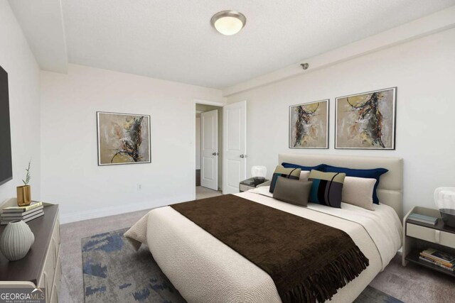 bedroom featuring carpet and baseboards