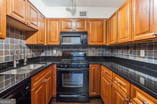 kitchen with brown cabinets, black appliances, and a sink