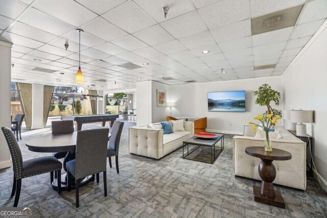 dining space featuring carpet, baseboards, and a paneled ceiling