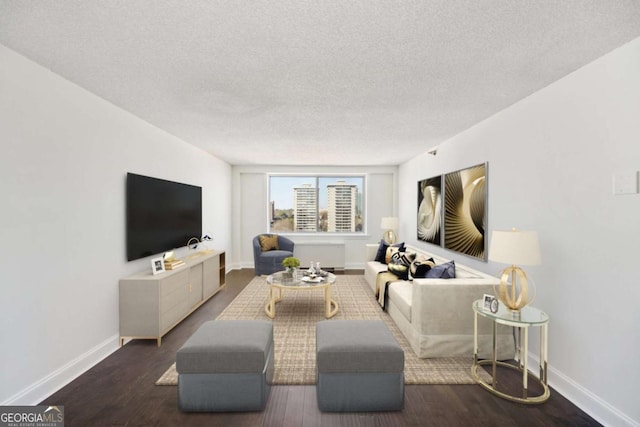 living area featuring baseboards, a textured ceiling, and wood finished floors