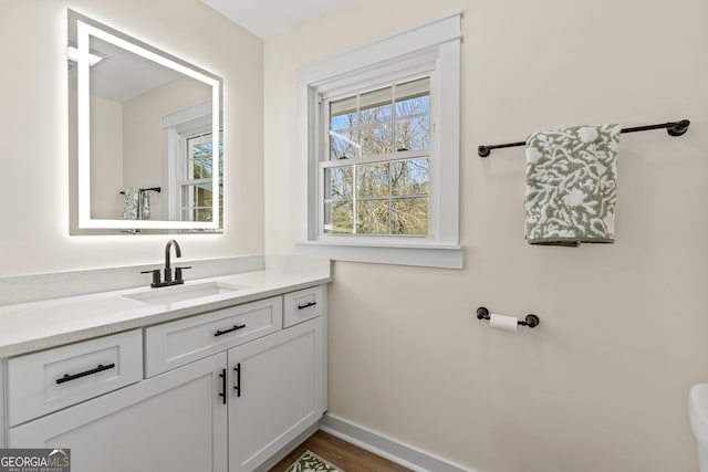 bathroom with baseboards and vanity