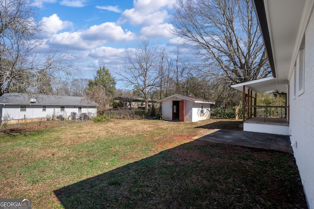 view of yard with an outdoor structure and fence