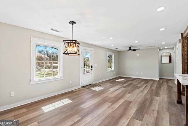 foyer featuring a ceiling fan, baseboards, visible vents, light wood-style flooring, and recessed lighting