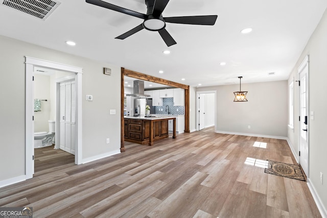 unfurnished living room with recessed lighting, visible vents, light wood-style floors, and ceiling fan