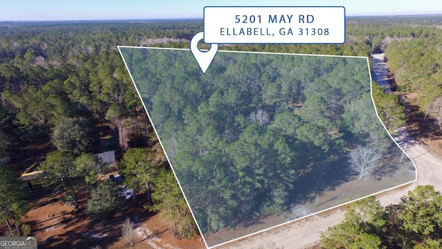 birds eye view of property featuring a wooded view