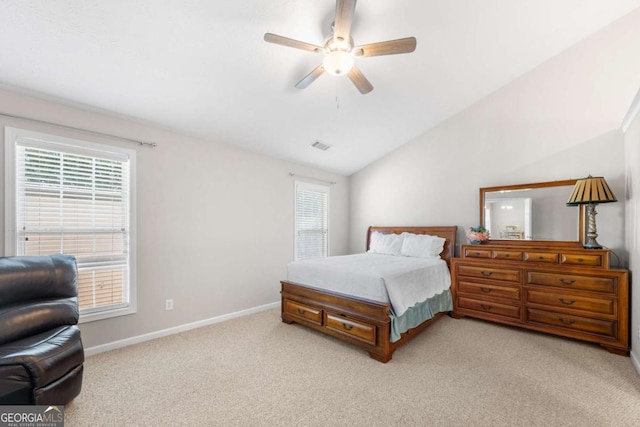 bedroom featuring lofted ceiling, multiple windows, light colored carpet, and baseboards