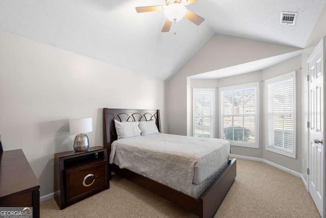 bedroom with visible vents, baseboards, lofted ceiling, light colored carpet, and ceiling fan