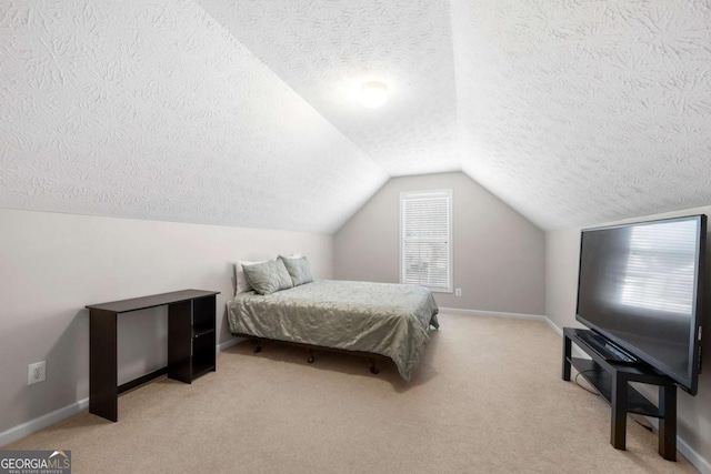 bedroom featuring baseboards, lofted ceiling, and light colored carpet