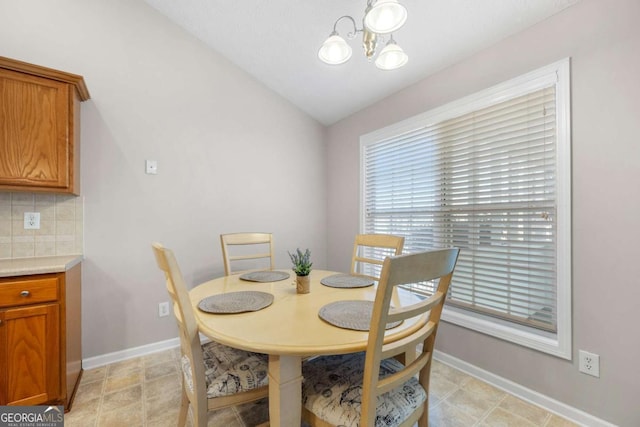 dining space featuring an inviting chandelier and baseboards