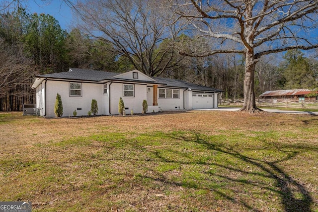 ranch-style home with a front yard, an attached garage, brick siding, and crawl space