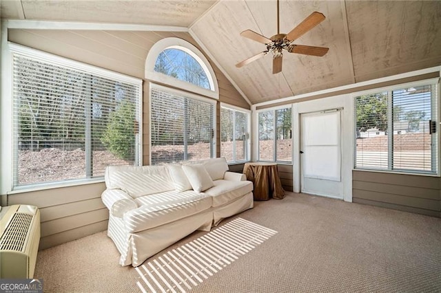 sunroom / solarium with vaulted ceiling, a wall unit AC, and a ceiling fan