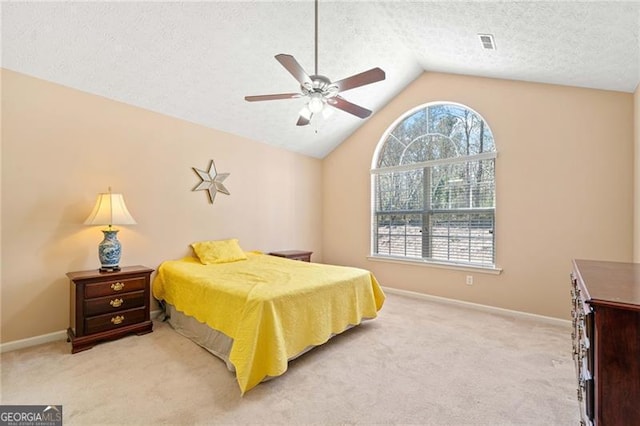 bedroom with vaulted ceiling, light colored carpet, baseboards, and a textured ceiling