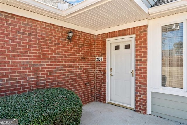 doorway to property with brick siding